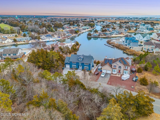 aerial view at dusk with a water view