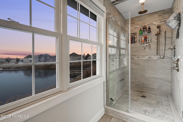 bathroom featuring a water view and walk in shower