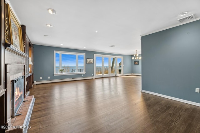 unfurnished living room with visible vents, baseboard heating, a glass covered fireplace, wood finished floors, and baseboards