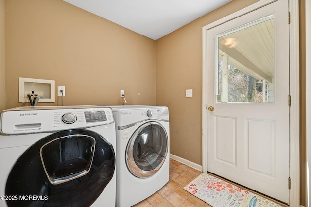 laundry room featuring washing machine and dryer, laundry area, and baseboards