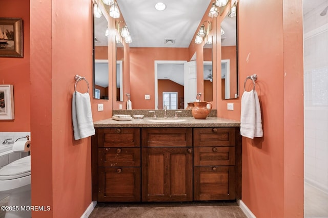 full bath with visible vents, toilet, vaulted ceiling, vanity, and baseboards