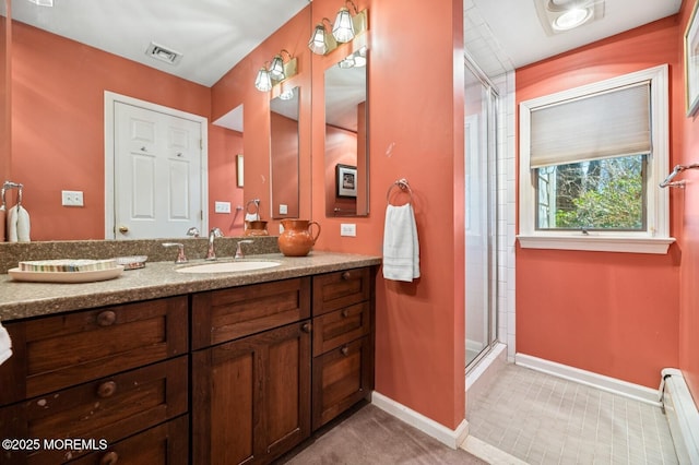 full bathroom featuring a stall shower, visible vents, baseboards, a baseboard radiator, and vanity