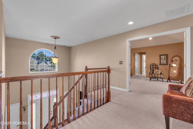 corridor with light carpet, baseboards, visible vents, an upstairs landing, and recessed lighting