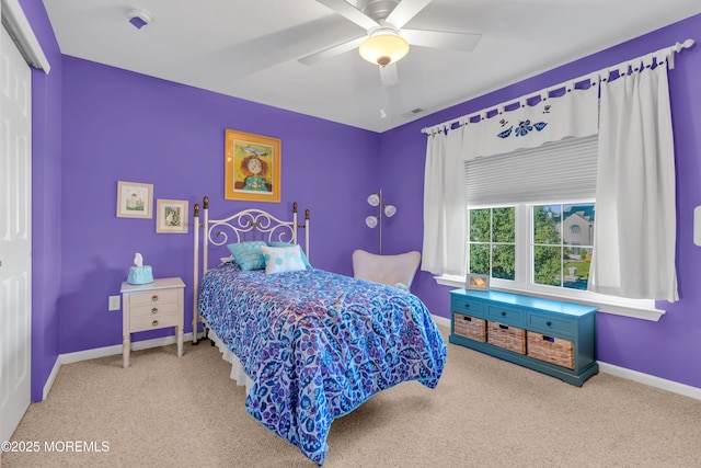 carpeted bedroom featuring visible vents, baseboards, a ceiling fan, and a closet