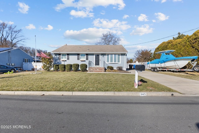 view of front of home featuring driveway, fence, and a front yard