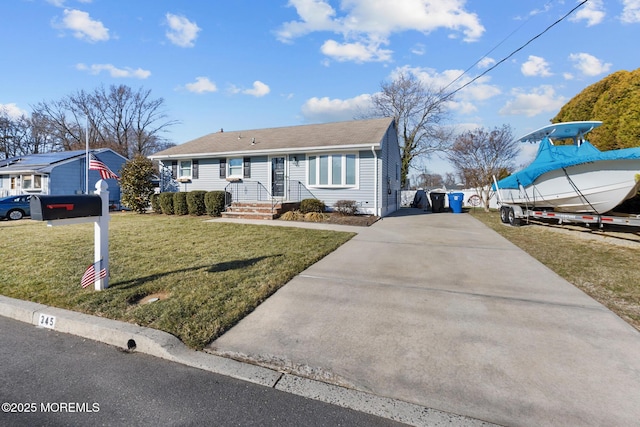 view of front of home with a front yard and concrete driveway