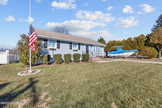 ranch-style house with a front yard and fence