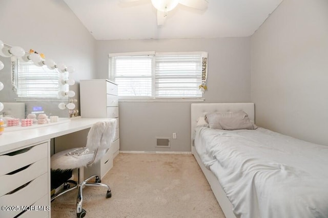 bedroom featuring multiple windows, ceiling fan, light carpet, and visible vents