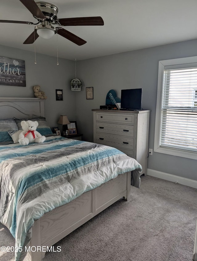 bedroom featuring light carpet, ceiling fan, and baseboards