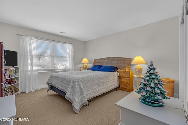 bedroom with light carpet, visible vents, and baseboards