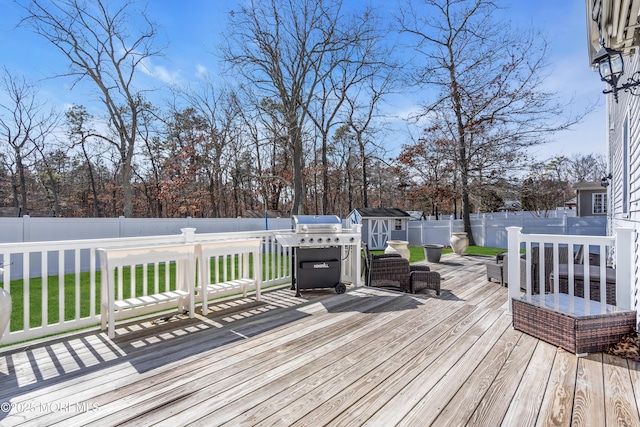 deck featuring a fenced backyard and grilling area