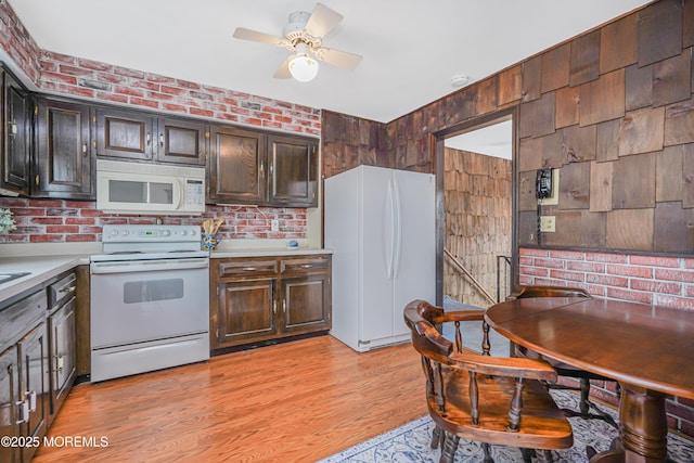 kitchen with white appliances, brick wall, ceiling fan, light countertops, and light wood-style floors