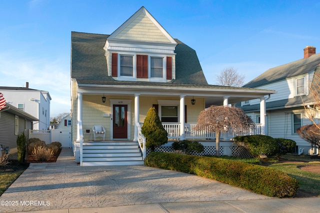 view of front of house featuring covered porch and roof with shingles