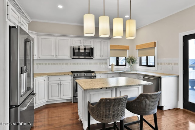 kitchen featuring decorative backsplash, appliances with stainless steel finishes, dark wood-type flooring, and crown molding