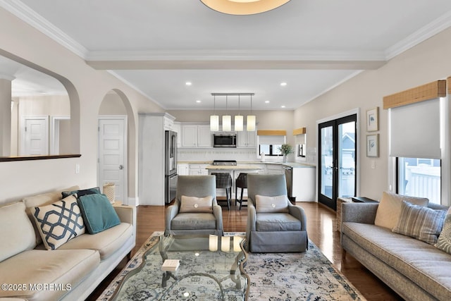 living room featuring arched walkways, french doors, crown molding, recessed lighting, and wood finished floors