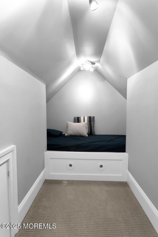 bonus room featuring lofted ceiling and baseboards