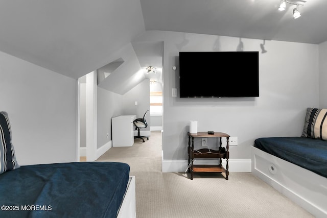 carpeted bedroom with lofted ceiling and baseboards