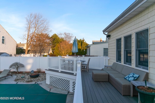 wooden deck featuring a patio area, fence, and an outdoor hangout area