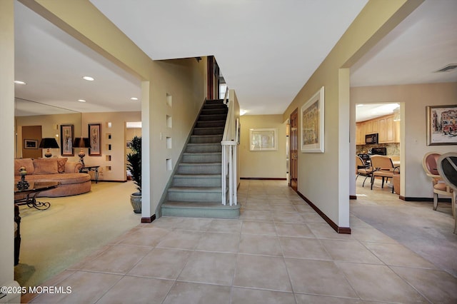 stairs featuring carpet floors, recessed lighting, visible vents, baseboards, and tile patterned floors