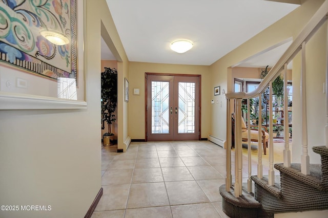 foyer featuring french doors, stairway, baseboard heating, light tile patterned flooring, and baseboards