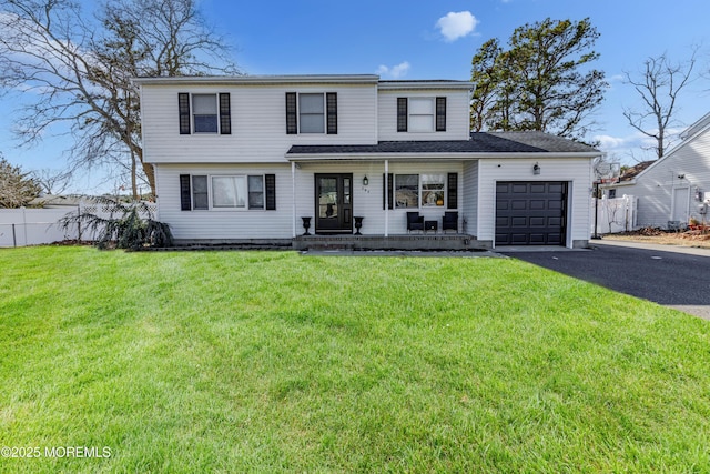 view of front of property with a porch, aphalt driveway, an attached garage, fence, and a front lawn