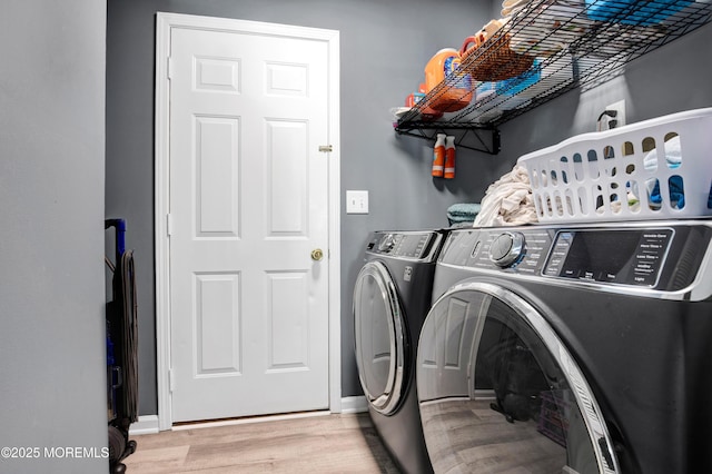 washroom with baseboards, laundry area, independent washer and dryer, and light wood-style floors