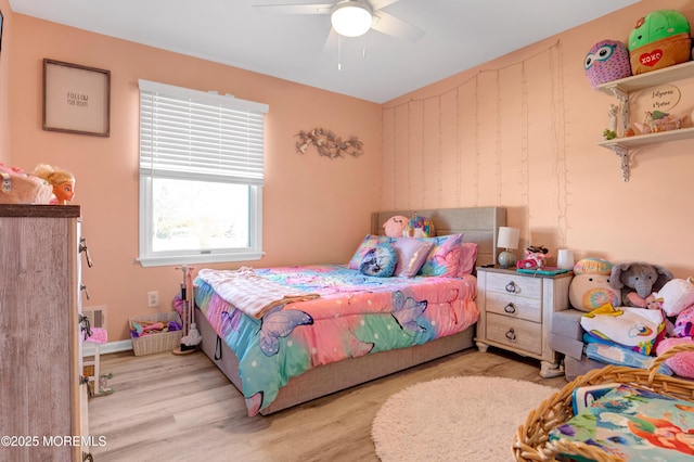 bedroom featuring light wood finished floors, baseboards, visible vents, and a ceiling fan