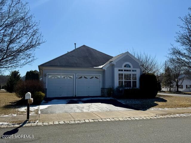 view of front of home with driveway and an attached garage