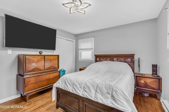 bedroom with baseboards and light wood-style floors