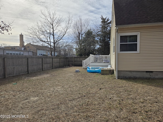 view of yard featuring a fenced backyard and a wooden deck