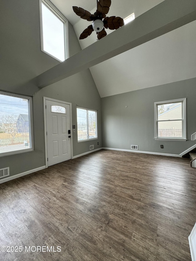 entrance foyer with high vaulted ceiling, dark wood-style flooring, visible vents, and baseboards