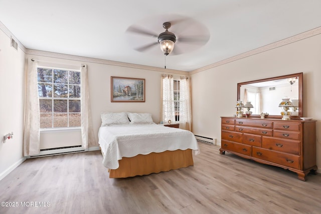 bedroom with light wood-type flooring, multiple windows, and baseboard heating