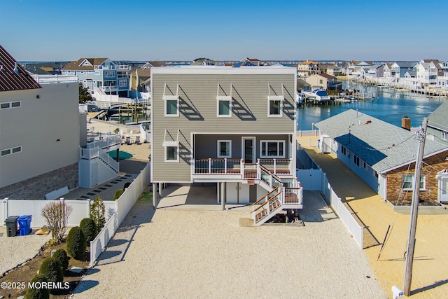 drone / aerial view featuring a water view and a residential view