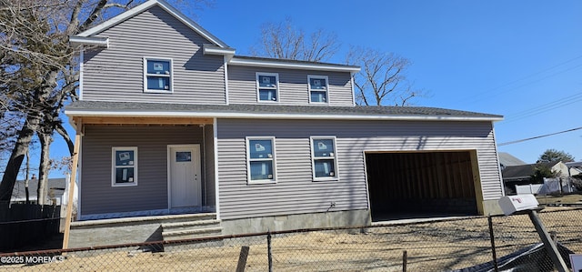 view of front of house with a fenced front yard and an attached garage