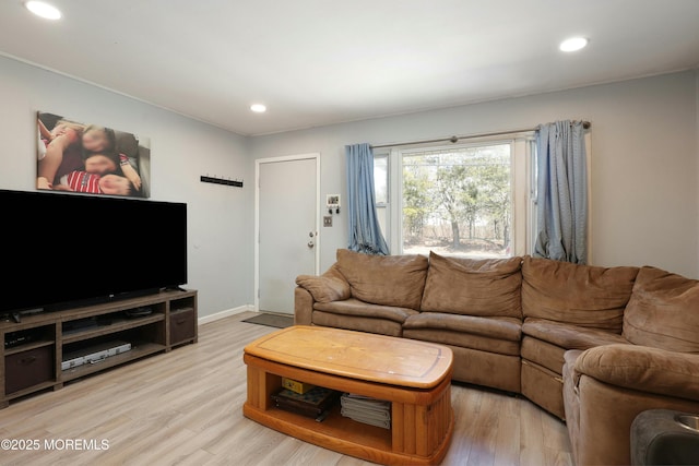 living room with baseboards, light wood-style flooring, and recessed lighting