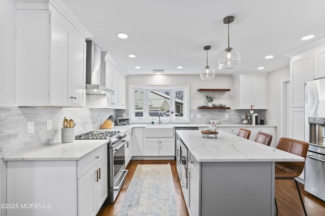 kitchen featuring stainless steel appliances, white cabinetry, a kitchen breakfast bar, and open shelves