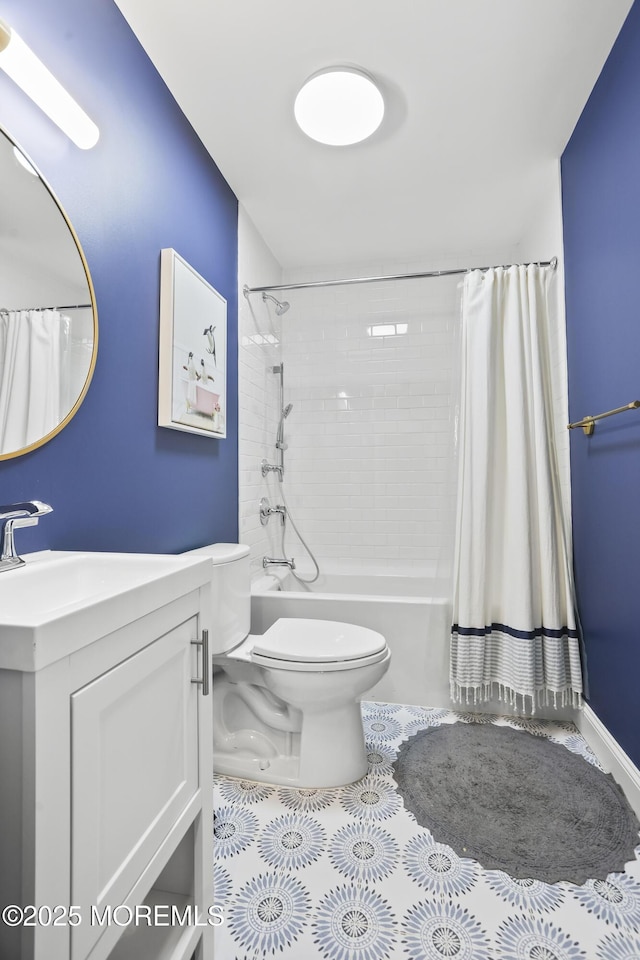 full bath with toilet, shower / bath combo with shower curtain, and vanity