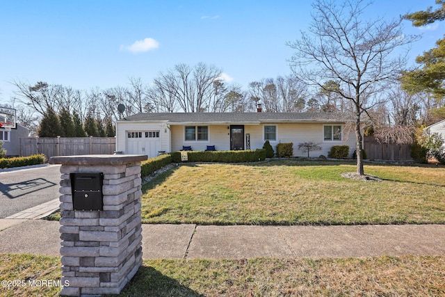 ranch-style home featuring a front lawn, fence, a garage, and driveway