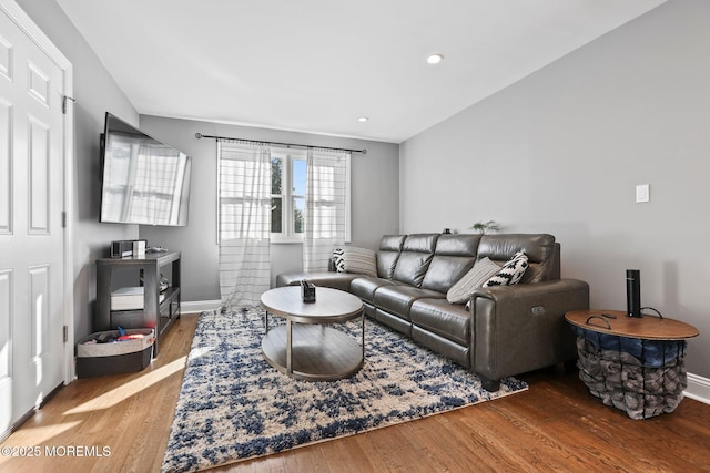 living room with vaulted ceiling, recessed lighting, wood finished floors, and baseboards