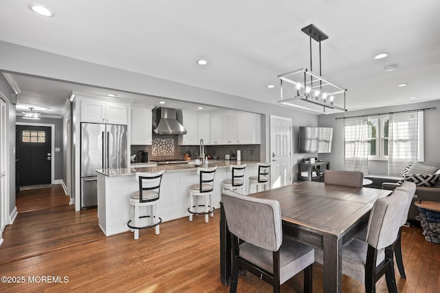 dining room featuring crown molding, recessed lighting, and dark wood-style floors