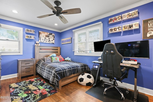 bedroom with baseboards, crown molding, and hardwood / wood-style flooring