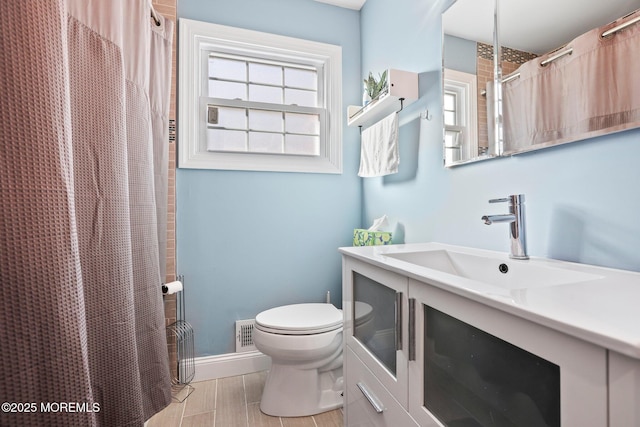 bathroom with visible vents, curtained shower, baseboards, toilet, and vanity