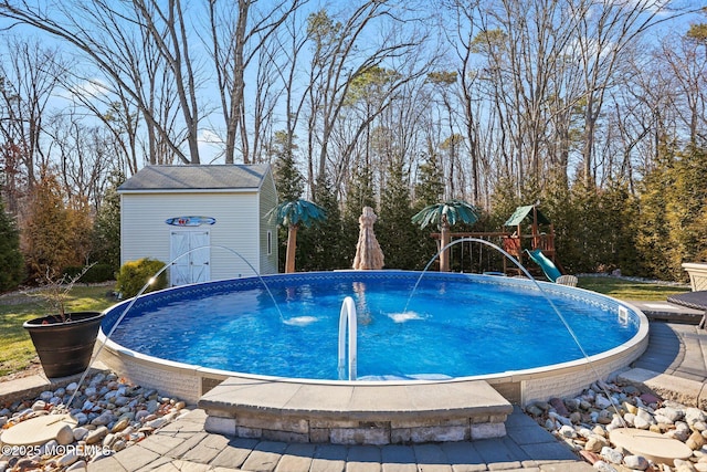 pool featuring a playground and an outdoor structure