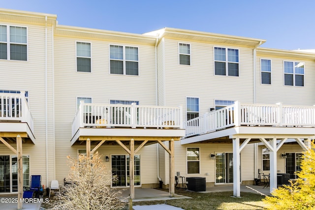 rear view of house with a patio and central AC unit