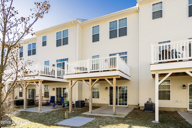 rear view of property with a patio and central air condition unit