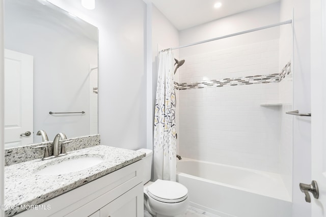 bathroom featuring toilet, shower / bath combo, and vanity