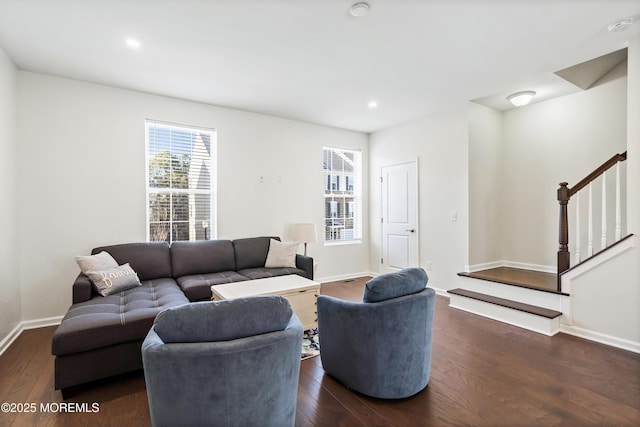 living area with baseboards, stairway, and dark wood-style flooring