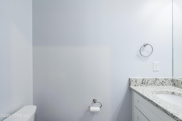 bathroom with toilet and vanity