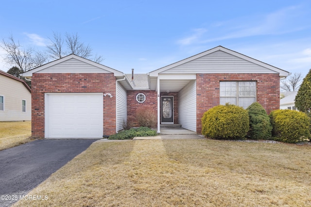 ranch-style house featuring a garage, brick siding, a front lawn, and aphalt driveway