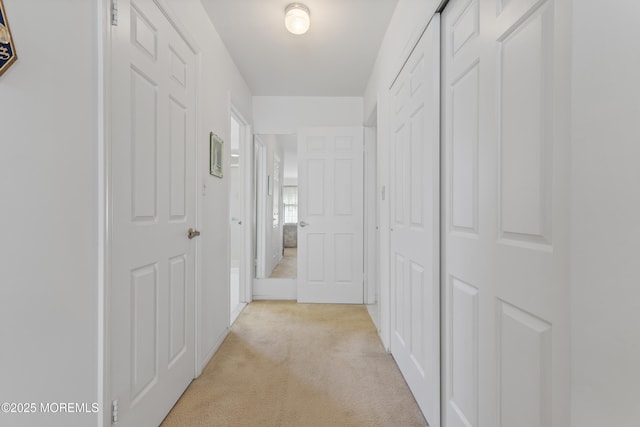 hall featuring light colored carpet